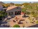 Aerial view of backyard patio with firepit, seating, and an outdoor kitchen at 25609 N 54Th Ln, Phoenix, AZ 85083