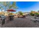 Spacious backyard featuring a built-in BBQ, fire pit, decorative landscaping and hardscape at 25609 N 54Th Ln, Phoenix, AZ 85083