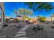 Wide open backyard with a BBQ, fire pit, decorative landscaping and hardscape at 25609 N 54Th Ln, Phoenix, AZ 85083