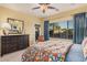 Cozy bedroom with ceiling fan and bright floral patterned bedding complements the large window at 25609 N 54Th Ln, Phoenix, AZ 85083