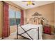 Bedroom with a cozy atmosphere, a large window, patterned bedding, and a ceiling fan at 25609 N 54Th Ln, Phoenix, AZ 85083