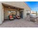 Relaxing covered patio with brick pavers, ceiling fan and grill with stone surround at 25609 N 54Th Ln, Phoenix, AZ 85083