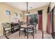 Dining area with a stylish table setting and a view of the outdoors through a large window at 25609 N 54Th Ln, Phoenix, AZ 85083