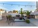 Backyard patio area with pavers, cushioned seating, and a built in grill at 2646 N Robin Ln, Mesa, AZ 85213