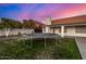 Backyard with trampoline, lush lawn, and colorful sunset at 2646 N Robin Ln, Mesa, AZ 85213