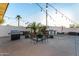 Outdoor kitchen and dining area with built-in BBQ and patio string lights at 2646 N Robin Ln, Mesa, AZ 85213