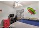 This bedroom features a ceiling fan, computer desk and red mini refrigerator at 2646 N Robin Ln, Mesa, AZ 85213