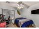 Cozy bedroom with a ceiling fan, desk, and TV at 2646 N Robin Ln, Mesa, AZ 85213