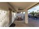 Covered patio space with an outdoor dining table, ceiling fan, and decorative string lights at 2646 N Robin Ln, Mesa, AZ 85213