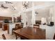 Open-concept dining room with an adjacent kitchen features vaulted ceilings and access to the living room with fireplace at 2646 N Robin Ln, Mesa, AZ 85213