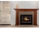 Close-up of a fireplace featuring a decorative wooden mantle and stone accents near a set of blinds at 2646 N Robin Ln, Mesa, AZ 85213