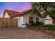 Front exterior view showcasing landscaping, a two-car garage, and privacy fence at 2646 N Robin Ln, Mesa, AZ 85213