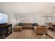 Bright living room with a sectional sofa, a TV, and neutral carpeting at 2646 N Robin Ln, Mesa, AZ 85213