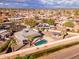 Aerial view of home featuring desert landscaping, a pool and a covered patio in a neighborhood setting at 26649 S Howard Dr, Sun Lakes, AZ 85248