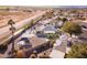 Aerial view of a home with a backyard pool, desert landscaping, and solar panels at 26649 S Howard Dr, Sun Lakes, AZ 85248