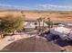 Aerial view of a desert home featuring mature trees, a two-car garage, and desert views at 26649 S Howard Dr, Sun Lakes, AZ 85248