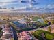 Aerial view of the golf course and neighborhood with tennis courts and lush desert landscaping at 26649 S Howard Dr, Sun Lakes, AZ 85248