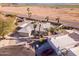 Aerial view of home with desert landscaping, palm trees and well-maintained grounds in a rural area at 26649 S Howard Dr, Sun Lakes, AZ 85248