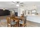 Open-concept dining area next to a modern kitchen with stainless steel appliances and white cabinetry at 26649 S Howard Dr, Sun Lakes, AZ 85248