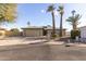 Charming single-story home with desert landscaping, palm trees, and attached two-car garage at 26649 S Howard Dr, Sun Lakes, AZ 85248