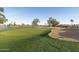 Expansive golf course with lush green grass, sand traps and mature trees, perfect for the avid golfer at 26649 S Howard Dr, Sun Lakes, AZ 85248