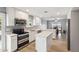 Bright kitchen featuring white cabinets, modern stainless steel appliances, and a center island at 26649 S Howard Dr, Sun Lakes, AZ 85248