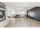 Spacious living room featuring wood-look tile flooring, neutral paint, and ample natural light at 26649 S Howard Dr, Sun Lakes, AZ 85248