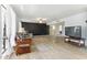 Comfortable living room featuring tile flooring, large windows, and neutral paint colors at 26649 S Howard Dr, Sun Lakes, AZ 85248