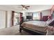 Bedroom features a ceiling fan, natural light, a TV, and sliding glass doors to the sunroom at 26649 S Howard Dr, Sun Lakes, AZ 85248