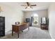 Office featuring a ceiling fan, gray carpet, and a window with a view to the front yard at 26649 S Howard Dr, Sun Lakes, AZ 85248