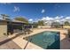 Exterior view of the pool and sunroom, surrounded by desert landscaping and clear skies at 26649 S Howard Dr, Sun Lakes, AZ 85248