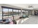 Sun room with many windows overlooking the pool features tile flooring and comfortable exercise equipment at 26649 S Howard Dr, Sun Lakes, AZ 85248