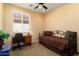 Cozy bedroom with a dedicated workspace, natural light, and a comfortable daybed at 27108 W Escuda Dr, Buckeye, AZ 85396