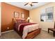 Comfortable bedroom with warm tones, a ceiling fan, natural lighting, and a plush bed at 27108 W Escuda Dr, Buckeye, AZ 85396