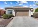 A well-maintained single-story home with a two-car garage and concrete driveway at 27108 W Escuda Dr, Buckeye, AZ 85396