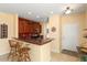 Kitchen counter bar area with dark wood cabinets and light walls at 27108 W Escuda Dr, Buckeye, AZ 85396