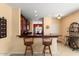 Kitchen counter bar area with dark wood cabinets and light walls at 27108 W Escuda Dr, Buckeye, AZ 85396