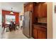 Well-lit kitchen area with stainless steel refrigerator and eat-in dining table at 27108 W Escuda Dr, Buckeye, AZ 85396