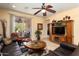 Inviting living room featuring a ceiling fan, tile flooring, and access to the outdoor patio at 27108 W Escuda Dr, Buckeye, AZ 85396