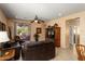 Cozy living room featuring a ceiling fan, tile flooring, and sliding glass doors to the patio at 27108 W Escuda Dr, Buckeye, AZ 85396