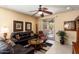 Comfortable living room with tile flooring and sliding glass doors leading to the outdoor patio at 27108 W Escuda Dr, Buckeye, AZ 85396