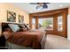 Main bedroom featuring a ceiling fan, bay window, and neutral carpeting at 27108 W Escuda Dr, Buckeye, AZ 85396