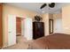 Main bedroom boasting an ensuite bathroom, closet space, and a ceiling fan at 27108 W Escuda Dr, Buckeye, AZ 85396