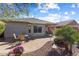 Well-manicured backyard featuring a paver patio with table and chairs, perfect for outdoor dining and entertaining guests at 27108 W Escuda Dr, Buckeye, AZ 85396