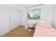 Carpeted bedroom features a white desk and a cozy metal bed with natural light, perfect for and teenagers at 28871 N Coal Ave, San Tan Valley, AZ 85143