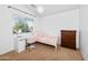 Bright carpeted bedroom features a cute white desk and a cozy metal bed for rest and relaxation at 28871 N Coal Ave, San Tan Valley, AZ 85143