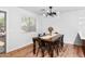 Bright dining room with modern lighting, a wooden table with chairs, and a sliding glass door at 28871 N Coal Ave, San Tan Valley, AZ 85143