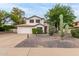 Charming two-story home with a two-car garage, desert landscaping, and mature Saguaro cacti at 3034 N Ricardo --, Mesa, AZ 85215