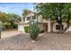 Charming two-story home with a two-car garage, desert landscaping, and mature Saguaro cacti at 3034 N Ricardo --, Mesa, AZ 85215