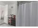 This bathroom area showcasing open storage and a bright, white shower curtain at 3129 W Pierce St, Phoenix, AZ 85009